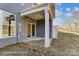 A covered patio on the rear of the home features a ceiling light and easy access to the backyard at 6259 Tea Olive Dr # 178, Harrisburg, NC 28075