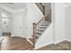 Elegant staircase with wooden steps, black metal railings, and white trim details at 6259 Tea Olive Dr # 178, Harrisburg, NC 28075