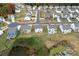 An aerial view of houses in a cozy neighborhood with mature trees and beautiful landscaping at 7618 Fenn Way, Indian Land, SC 29707