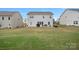 Backyard featuring a well-maintained lawn, patio area, and view of the property's rear elevation at 7618 Fenn Way, Indian Land, SC 29707