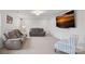 Basement featuring reclining sofas, a cozy armchair, and a mounted TV, perfect for relaxing and watching movies at 7618 Fenn Way, Indian Land, SC 29707