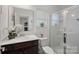 Bathroom featuring a glass shower, vanity with ample counter space, and a decorative mirror with plenty of natural light at 7618 Fenn Way, Indian Land, SC 29707