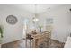 Cozy dining area with a simple table, seating for six, and natural light from a window at 7618 Fenn Way, Indian Land, SC 29707