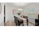 Elegant dining room with chandelier, window with blinds, and seating for six at 7618 Fenn Way, Indian Land, SC 29707