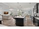 Spacious kitchen with open concept to the living and dining areas, featuring dark cabinets at 7618 Fenn Way, Indian Land, SC 29707