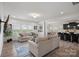 Living room with a view of the dining area and kitchen with black countertops and a large island at 7618 Fenn Way, Indian Land, SC 29707