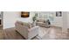 Bright living room with hardwood floors, neutral-colored sofas, and large windows that bring in natural light at 7618 Fenn Way, Indian Land, SC 29707