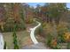 A winding paved path through a colorful autumn forest is perfect for a relaxing walk at 7618 Fenn Way, Indian Land, SC 29707