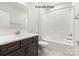 Bathroom with dark vanity, white bathtub, and tiled floor at 1029 Wandsworth Pl # Ken0105, Charlotte, NC 28215