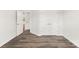 Bedroom with light gray walls, wood-look flooring, and double doors to closet at 1029 Wandsworth Pl # Ken0105, Charlotte, NC 28215