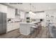 Modern kitchen with white cabinets, large island, and stainless steel appliances at 1029 Wandsworth Pl # Ken0105, Charlotte, NC 28215