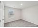 Bedroom features a window and neutral walls, trim, and carpet at 106 Obadiah Ct, Troutman, NC 28115