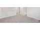 Upstairs loft area features neutral walls, trim and carpet at 106 Obadiah Ct, Troutman, NC 28115