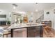 Granite kitchen island with double sink, dishwasher, and views into living room at 11319 Savannah Creek Dr, Charlotte, NC 28273