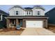 Two-story home with gray siding, brick accents, and a two-car garage at 118 Satchel Ct, Mooresville, NC 28115