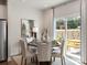 Elegant dining room with seating for six and sliding glass doors to the patio at 122 Satchel Ct, Troutman, NC 28115