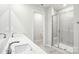 Bright bathroom showcasing double sinks, a glass shower door, and modern fixtures at 122 Satchel Ct, Troutman, NC 28115