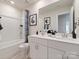 Well-lit bathroom featuring double vanity sinks, white cabinets, and a shower-tub combo with stylish fixtures at 122 Satchel Ct, Troutman, NC 28115