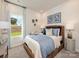 Comfortable bedroom featuring a wicker bed frame, soft bedding, side tables and natural light at 122 Satchel Ct, Troutman, NC 28115