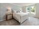 Comfortable bedroom featuring a bed frame, soft bedding, side tables, nightstands and natural light at 122 Satchel Ct, Troutman, NC 28115