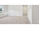Carpeted bedroom with white walls features a large window with neighborhood views at 122 Satchel Ct, Troutman, NC 28115