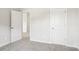 Neutral bedroom featuring a carpeted floor, a closet door, and an open doorway at 122 Satchel Ct, Troutman, NC 28115