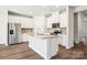 Modern kitchen boasts stainless appliances, white cabinets and a large island with granite countertops at 122 Satchel Ct, Troutman, NC 28115