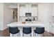 Bright kitchen featuring white cabinets, stainless steel appliances, and a large quartz island with stylish seating at 122 Satchel Ct, Troutman, NC 28115
