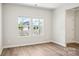 Bright living room features wood floors, two windows, and light neutral paint throughout at 122 Satchel Ct, Troutman, NC 28115