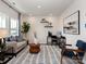 Modern living room with neutral tones, stylish decor, a patterned rug and plenty of natural light at 122 Satchel Ct, Troutman, NC 28115