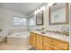 Bright bathroom featuring double vanity with granite countertops, garden tub and tile flooring at 3195 Hadden Hall Blvd, Fort Mill, SC 29715