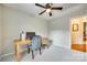 This bedroom has a ceiling fan, a desk and chair, and is carpeted at 3195 Hadden Hall Blvd, Fort Mill, SC 29715