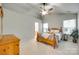 Bright main bedroom with a ceiling fan, dresser, and ensuite bath providing comfort and convenience at 3195 Hadden Hall Blvd, Fort Mill, SC 29715