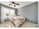 Bedroom featuring neutral carpet, a ceiling fan, and ample natural light from a large window at 3195 Hadden Hall Blvd, Fort Mill, SC 29715