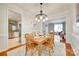 Dining room with wood table, chandelier, and views into the living room and kitchen at 3195 Hadden Hall Blvd, Fort Mill, SC 29715