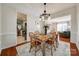 Open dining room featuring a wooden table, hardwood floors, and stylish decor at 3195 Hadden Hall Blvd, Fort Mill, SC 29715