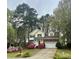 Charming two-story home boasts a brick-and-siding facade, manicured lawn, and flowering shrubs at 3195 Hadden Hall Blvd, Fort Mill, SC 29715