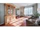Comfortable living room with hardwood flooring, bright windows, and a china cabinet at 3195 Hadden Hall Blvd, Fort Mill, SC 29715