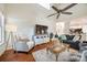 Bright living room features hardwood floors, ceiling fan, fireplace, and open kitchen access at 3195 Hadden Hall Blvd, Fort Mill, SC 29715