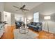 Open-concept living room with vaulted ceilings, ceiling fan, and hardwood floors leading to the kitchen at 3195 Hadden Hall Blvd, Fort Mill, SC 29715