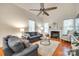 Spacious living room with vaulted ceilings, fireplace, ceiling fan, and comfortable gray couches at 3195 Hadden Hall Blvd, Fort Mill, SC 29715