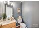 Cozy powder room featuring stylish decor, a wood vanity, and gray walls at 3195 Hadden Hall Blvd, Fort Mill, SC 29715