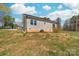 Backyard view of the home featuring a grassy lot and small staircase to back entry at 501 Ed Wilson Rd, Bessemer City, NC 28016