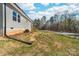 Exterior view of the home with a grassy yard, small staircase to back entry, and trees at 501 Ed Wilson Rd, Bessemer City, NC 28016