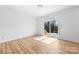 Bright bedroom features wood-look floors and a sliding glass door to the back deck at 501 Ed Wilson Rd, Bessemer City, NC 28016