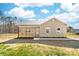 Tan home featuring a charming front porch with wood railing and a well-maintained yard under a partly cloudy blue sky at 501 Ed Wilson Rd, Bessemer City, NC 28016