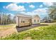 Home exterior showcasing vinyl siding, a welcoming front porch with wooden railings, and partial views of the yard and sky at 501 Ed Wilson Rd, Bessemer City, NC 28016