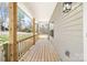 Spacious front porch with wood flooring and railings, offering ample space for seating and outdoor enjoyment at 501 Ed Wilson Rd, Bessemer City, NC 28016