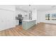 Open kitchen with modern design, island with seating, white cabinets and stainless steel appliances at 501 Ed Wilson Rd, Bessemer City, NC 28016