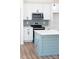 Kitchen features white cabinetry, a modern island with seating, and stainless steel appliances at 501 Ed Wilson Rd, Bessemer City, NC 28016